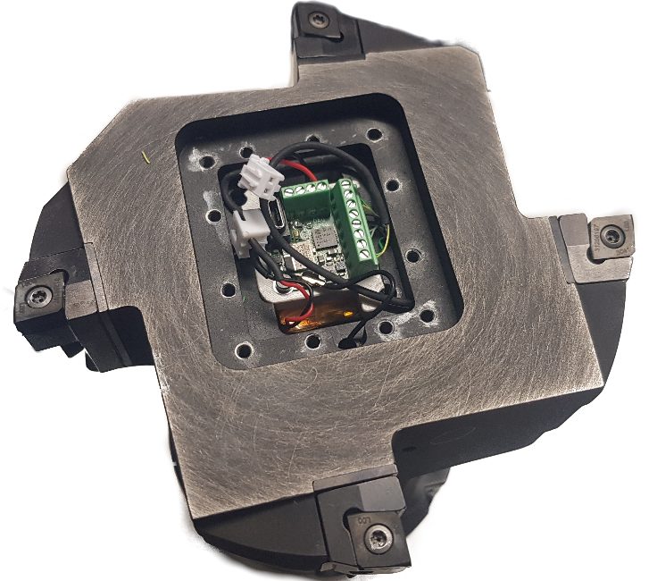 Sensor-integrated precision boring tool with the telemetry module and battery visible in the tool body.